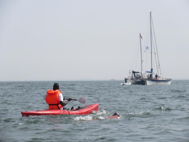Ben Hooper and his kayaker as he swims the first mile of this trans-Atlantic attempt